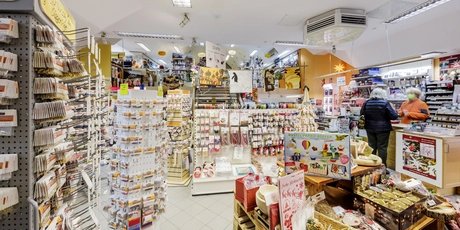 Crafts and art store in Germany with children and adults choosing art supplies, including paints, brushes, and DIY kits, promoting creativity, learning, and hands-on projects.